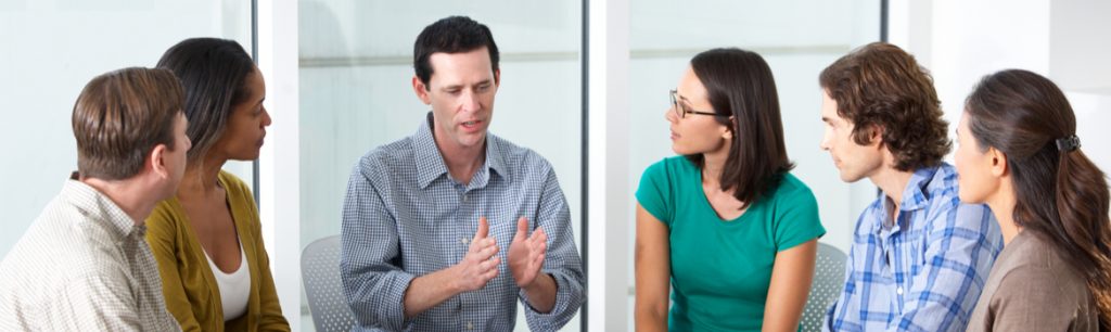 Alcohol Rehab in Colorado - During alcohol rehab in Colorado a group small group of 5 people listen as their therapist talks about coping skills.